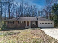 Charming brick ranch-style home with an attached garage and well-maintained landscaping at 1131 Mayfield Dr, Decatur, GA 30033