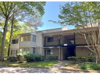 A charming condo with traditional architecture and a covered entry, surrounded by mature trees and landscaping at 3020 Wingate Way, Sandy Springs, GA 30350