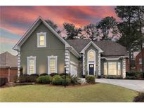 Beautiful home with a manicured front lawn and a charming architectural design at 9795 Terrace Lake Pointe, Roswell, GA 30076