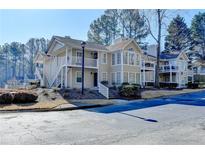 Well-maintained condominium complex with lush landscaping, parking, and abundant natural light at 309 Berkeley Woods Dr, Duluth, GA 30096