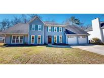 Charming two-story home with a well-manicured lawn, attached garage, and pleasing curb appeal at 1317 Bustling Sw Ln, Marietta, GA 30064