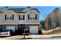 Charming townhome with a well-maintained front yard and attached garage at 2004 Burns View Ln, Lawrenceville, GA 30044