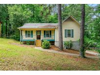 Charming single Gathering home with a cozy front porch and yard at 7281 Fernwood Dr, Riverdale, GA 30296