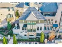 Beautiful three-story home showcasing a rooftop terrace and community pool at 6669 Encore Blvd, Atlanta, GA 30328