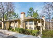 Inviting condo exterior with lush landscaping and private balconies, creating a tranquil living experience at 806 Lismore Se, Smyrna, GA 30080