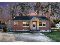Charming brick home with stone accents, well-manicured lawn, and a cozy, inviting entryway at 4809 Lavista Rd, Tucker, GA 30084