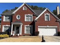 Charming two-story brick home with a manicured lawn and attached two-car garage at 4107 Suwanee Trail Way, Buford, GA 30518