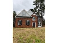 Charming brick home featuring a mix of classic and modern architectural design elements at 6910 Stone Breeze Dr, Stone Mountain, GA 30087