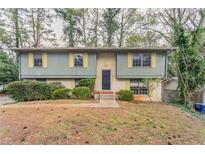 Split level home with brick and siding and manicured landscaping at 2897 Hedgewood Nw Dr, Atlanta, GA 30311