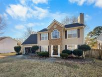 Charming two-story home featuring a brick and siding facade, complemented by a well-maintained lawn and front garden at 715 Alcovy Springs Dr, Lawrenceville, GA 30045