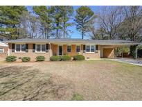 Charming brick home with a well-maintained lawn and a convenient attached carport at 773 Forest Ridge Se Dr, Marietta, GA 30067