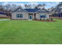 Charming brick home with a well manicured lawn and beautiful landscaping at 5291 Tuscany Dr, Douglasville, GA 30135