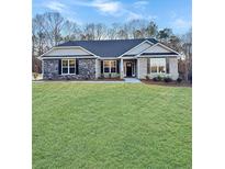 Charming one-story home featuring a well-manicured lawn and stone accents at 5331 Tuscany Dr, Douglasville, GA 30135