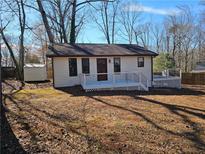 Charming single-story home with a deck and a well-maintained front yard, offering a cozy and inviting appeal at 1580 Turner Rd, Cumming, GA 30041