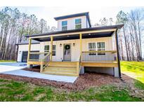 Charming home featuring a welcoming front porch with wooden steps and a beautifully landscaped yard at 279 Laura Cir, Bowdon, GA 30108