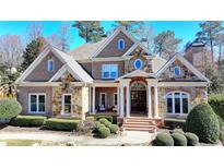 Beautiful brick home featuring a stone facade, manicured landscaping, and a welcoming front entrance at 2892 Darlington Run, Duluth, GA 30097
