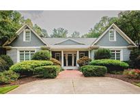 Charming gray home with manicured landscaping and a brick walkway leading to the welcoming front entrance at 3045 Camp Branch Rd, Buford, GA 30519