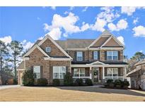Charming brick home with a welcoming front porch and manicured lawn at 170 Wheaten Dr, Woodstock, GA 30188