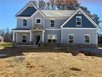 Two-story home featuring a mix of vertical siding and shake accents at 1452 Stephens View Dr, Loganville, GA 30052