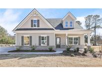 Charming single-Gathering home features a welcoming front porch, gray siding, and beautifully trimmed windows at 1461 Stephens View Dr, Loganville, GA 30052