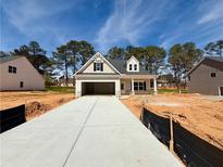 Charming new construction home featuring a two-car garage and welcoming front porch at 1461 Stephens View Dr, Loganville, GA 30052