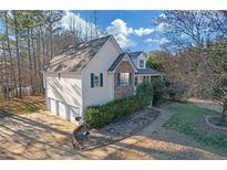 Charming home featuring stone accents, vinyl siding, and a well-maintained three-car attached garage at 21 Barrington Ct, Hiram, GA 30141
