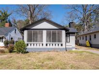 Charming bungalow-style house with a screened front porch and painted brick exterior at 2147 Cascade Sw Rd, Atlanta, GA 30311