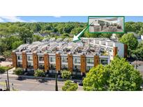 Modern townhome exterior showcasing a rooftop deck with outdoor kitchen and dining, surrounded by lush greenery at 1307 Glenwood Se Ave, Atlanta, GA 30316