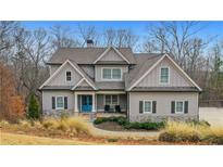 Charming two-story home with stone accents and a welcoming blue front door at 325 William Falls Dr, Canton, GA 30114