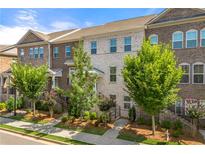 Charming townhomes with brick facades, complemented by manicured landscaping and small trees at 3538 Davenport Rd, Duluth, GA 30096