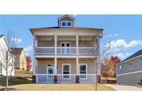 Charming two-story home featuring a double porch, providing ample outdoor relaxation space at 2342 Terrace View Sw Cir, Atlanta, GA 30315