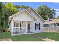 Charming white cottage-style home with a welcoming front porch and well-maintained lawn at 1705 Evans, Atlanta, GA 30310