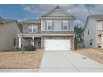 Charming two-story home with stone accents, gray siding, and a two-car garage at 981 Sonoma Dr, Lawrenceville, GA 30045