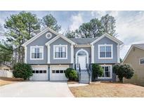 Charming two-story home with a two-car garage, landscaped yard, and traditional architectural details at 4170 Hopkins Bluff Way, Duluth, GA 30096