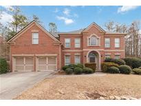 Beautiful two-story brick home with a well-manicured lawn and two-car garage at 1203 Bonshaw Trl, Marietta, GA 30064