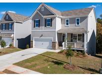 Charming two-story home featuring a covered porch, well-manicured lawn, and attached one car garage at 218 Highgrove Way, Dallas, GA 30157