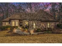 Charming brick home featuring a well-manicured lawn and an inviting entrance walkway at 490 Revenna Trl, Fayetteville, GA 30214