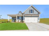 Charming single-Gathering home with blue siding, white garage door, and well-manicured lawn at 47 Colonial Ter, Villa Rica, GA 30180