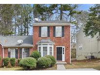 Charming brick two-story home with well-maintained landscaping and black shutters at 3188 Kingswood Gln, Decatur, GA 30034