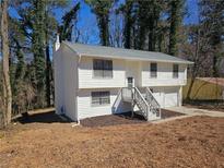 Charming two-story home with white siding, a well-manicured lawn, and a welcoming front entrance at 434 Ridgetop Nw Dr, Acworth, GA 30102