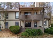 Charming two-story condo with a private balcony and well-maintained landscaping creating an inviting curb appeal at 707 Woodcliff Dr, Atlanta, GA 30350