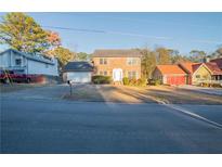 Charming two-story brick home with a well-manicured lawn and an attached two-car garage at 895 Smoketree Dr, Tucker, GA 30084