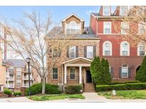 Charming brick townhome featuring a well-manicured front yard and a welcoming entrance at 142 Perimeter Walk, Atlanta, GA 30338