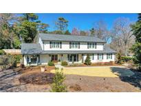 Charming two-story home with a landscaped front yard, complemented by mature trees and neutral siding at 1285 Oakhaven Dr, Roswell, GA 30075