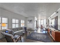 Bright living room featuring hardwood floors, large windows, and modern furnishings, perfect for relaxation and entertaining at 3435 Kingsboro Ne Rd # 1701, Atlanta, GA 30326