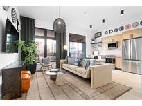 Inviting living room with hardwood floors, modern decor, and abundant natural light from large windows at 567 Ponce De Leon Ne Ave # 317, Atlanta, GA 30308