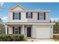 Charming two-story home with a welcoming front porch and neatly landscaped front yard at 1241 To Lani Path, Stone Mountain, GA 30083