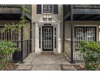 Stylish condo entrance featuring a classic white door with decorative columns and black iron railings at 3529 Essex Ave # 75, Atlanta, GA 30339