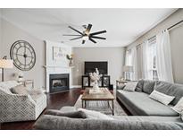 Inviting living room with a fireplace, modern ceiling fan, and comfortable seating arrangement at 2471 Bridlewood Se Dr # 8, Atlanta, GA 30339