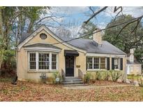Charming, one-story brick home with bay window, chimney, black shutters and an inviting front entrance at 1815 Monroe Ne Dr, Atlanta, GA 30324